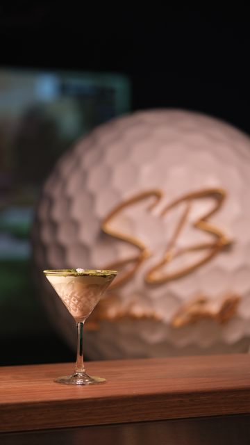 Signature cocktail — martini with golf ball background